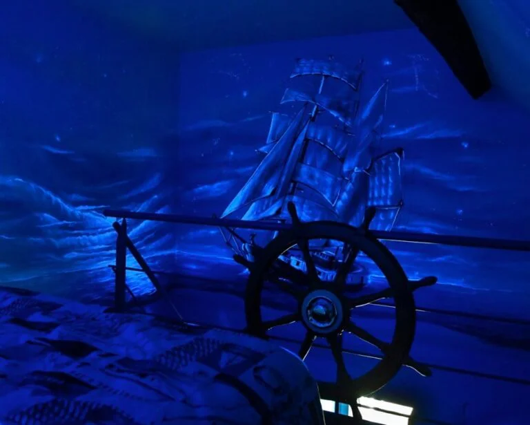Décor maritime bleu de la suite inspirée du Titanic à River Lodge